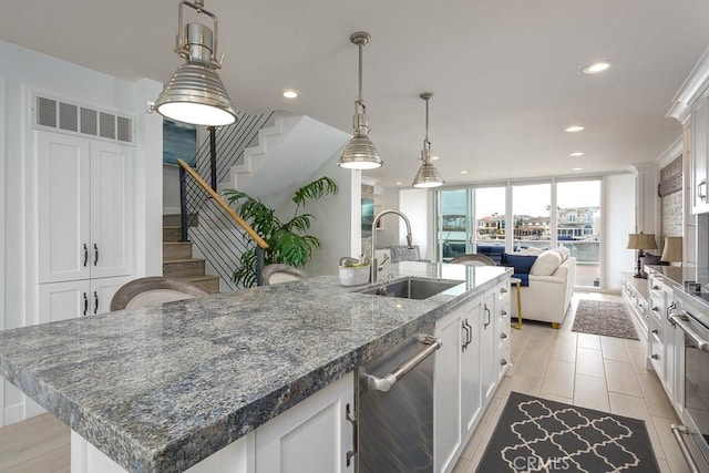 4073 Aladdin Dr, Huntington Beach, CA 92649 - kitchen featuring dishwasher, recessed lighting, open floor plan, white cabinetry, and decorative light fixtures