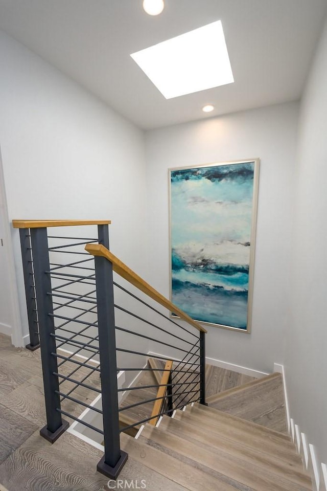 4073 Aladdin Dr, Huntington Beach, CA 92649 - stairs featuring a skylight, recessed lighting, and wood finished floors