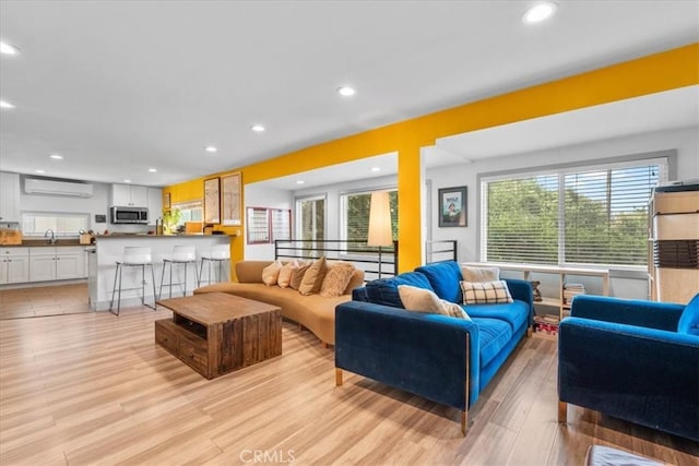 606 N Bonnie Brae St, Los Angeles, CA 90026 - living area featuring a wall mounted air conditioner, light wood finished floors, healthy amount of natural light, and recessed lighting
