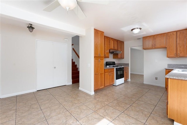 17571 Shamrock Ave, Fontana, CA 92336 - kitchen featuring white gas stove, under cabinet range hood, a ceiling fan, light stone countertops, and light tile patterned floors