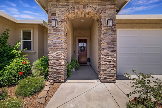 10 Harmony Park Cir, Chico, CA 95973 - view of exterior entry with stone siding, a garage, and stucco siding