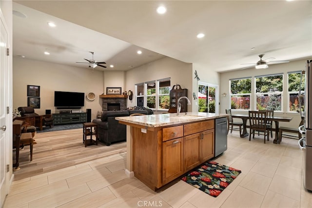 10 Harmony Park Cir, Chico, CA 95973 - kitchen with a ceiling fan, appliances with stainless steel finishes, brown cabinetry, healthy amount of natural light, and recessed lighting