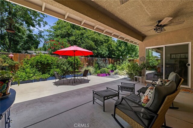 10 Harmony Park Cir, Chico, CA 95973 - fenced backyard with outdoor dining area, a patio area, ceiling fan, and an outdoor living space