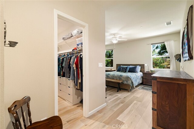 10 Harmony Park Cir, Chico, CA 95973 - bedroom with light wood-style floors, a spacious closet, a closet, and ceiling fan