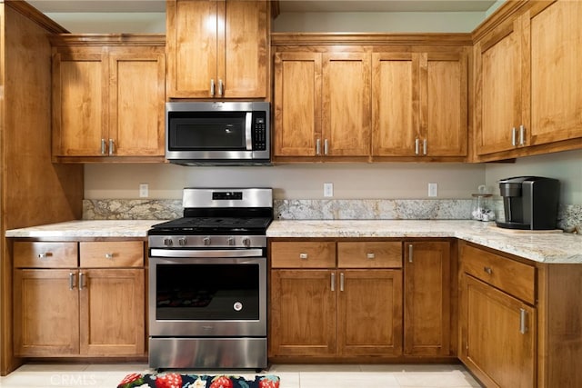 10 Harmony Park Cir, Chico, CA 95973 - kitchen featuring appliances with stainless steel finishes, brown cabinets, and light stone counters