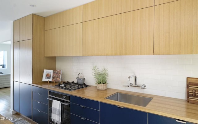 1070 Montecito Dr, Los Angeles, CA 90031 - kitchen with black oven, modern cabinets, stainless steel gas cooktop, and blue cabinetry