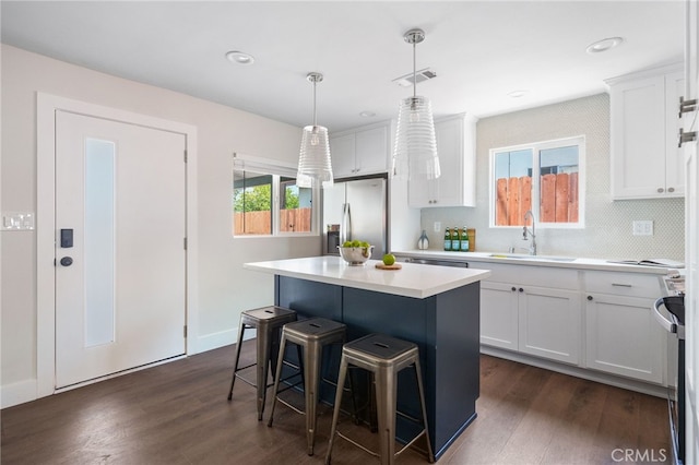 112 W Norwood Pl, San Gabriel, CA 91776 - kitchen with stainless steel fridge with ice dispenser, a breakfast bar area, dark wood-style floors, a center island, and white cabinets