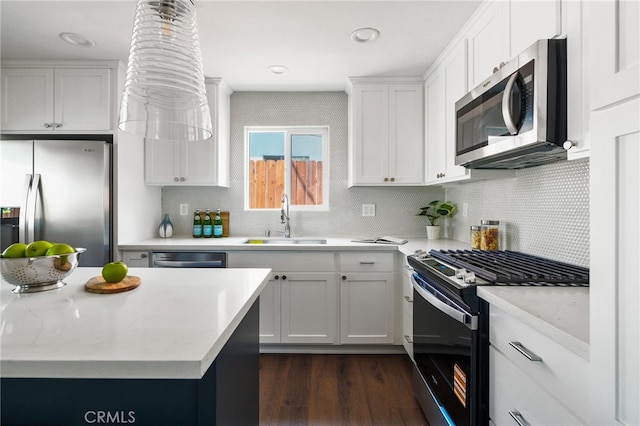 112 W Norwood Pl, San Gabriel, CA 91776 - kitchen featuring stainless steel appliances, dark wood finished floors, decorative backsplash, and white cabinetry