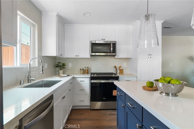 112 W Norwood Pl, San Gabriel, CA 91776 - kitchen with stainless steel appliances, blue cabinetry, dark wood-style flooring, and white cabinets