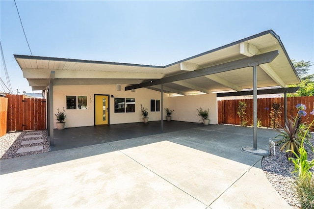 112 W Norwood Pl, San Gabriel, CA 91776 - view of front facade with stucco siding, an attached carport, and driveway