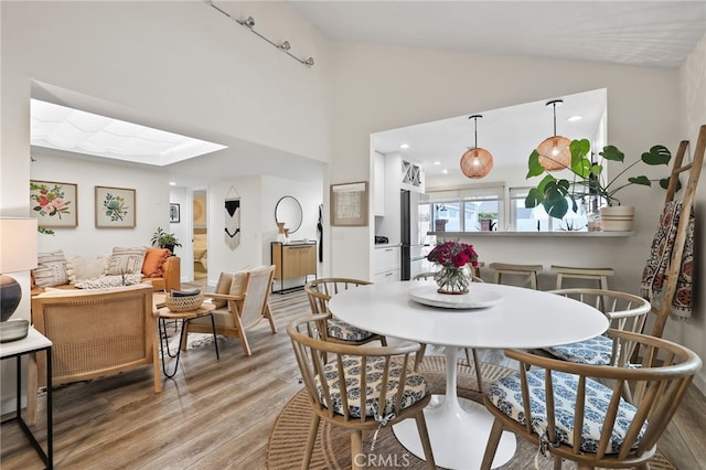 33586 Via Corvalian Unit 23, Dana Point, CA 92629 - dining room with light wood-style flooring, lofted ceiling, and a skylight