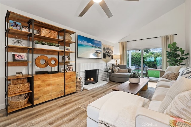 33586 Via Corvalian Unit 23, Dana Point, CA 92629 - living area with ceiling fan, light wood-type flooring, a brick fireplace, and high vaulted ceiling