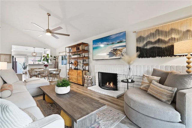33586 Via Corvalian Unit 23, Dana Point, CA 92629 - living room with wood finished floors, a ceiling fan, a fireplace, and high vaulted ceiling