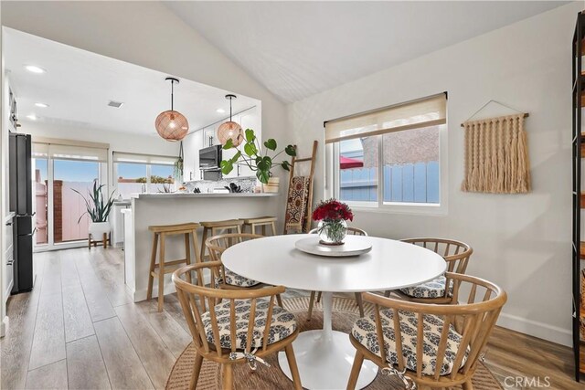 33586 Via Corvalian Unit 23, Dana Point, CA 92629 - dining area with light wood finished floors, lofted ceiling, and recessed lighting