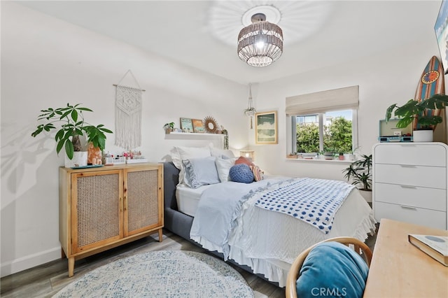 33586 Via Corvalian Unit 23, Dana Point, CA 92629 - bedroom featuring wood finished floors and a chandelier