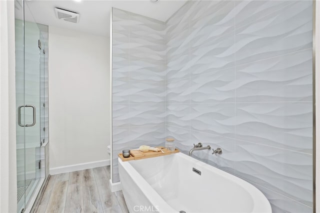 33586 Via Corvalian Unit 23, Dana Point, CA 92629 - full bath featuring wood finished floors, a freestanding bath, and a shower stall