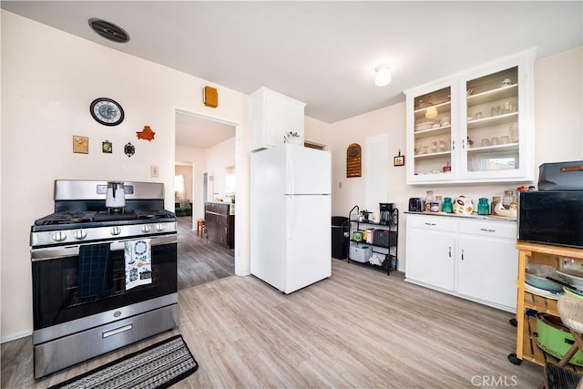 5870 Lemon Ave, Long Beach, CA 90805 - kitchen featuring freestanding refrigerator, gas range, white cabinets, light wood-style floors, and glass insert cabinets
