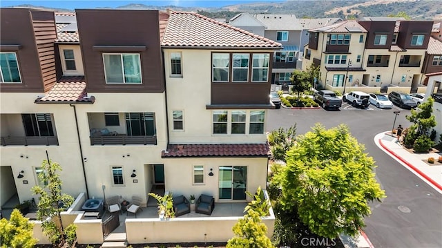 111 Juniper Dr, Rancho Mission Viejo, CA 92694 - view of building exterior with uncovered parking, a residential view, and a mountain view