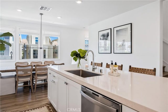 111 Juniper Dr, Rancho Mission Viejo, CA 92694 - kitchen with stainless steel dishwasher, light countertops, white cabinetry, wood finished floors, and recessed lighting