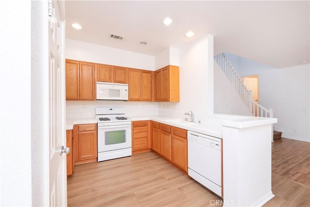 38133 Mendocino Way, Palmdale, CA 93550 - kitchen featuring white appliances, light wood-type flooring, a peninsula, light countertops, and recessed lighting