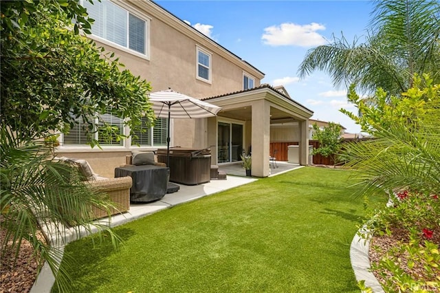 29273 Caravel Dr, Menifee, CA 92585 - back of house with a hot tub, stucco siding, a patio area, and a yard
