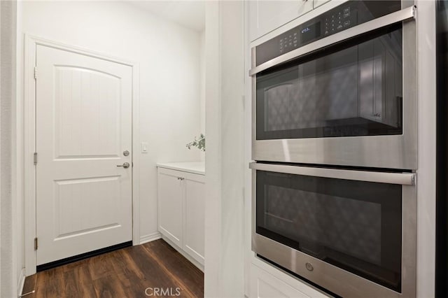 29273 Caravel Dr, Menifee, CA 92585 - kitchen featuring stainless steel double oven, dark wood finished floors, white cabinetry, and light countertops