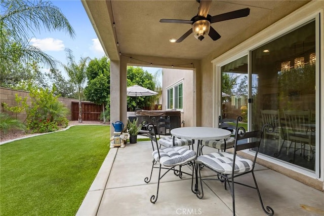 29273 Caravel Dr, Menifee, CA 92585 - fenced backyard with a patio, a ceiling fan, and outdoor dining area