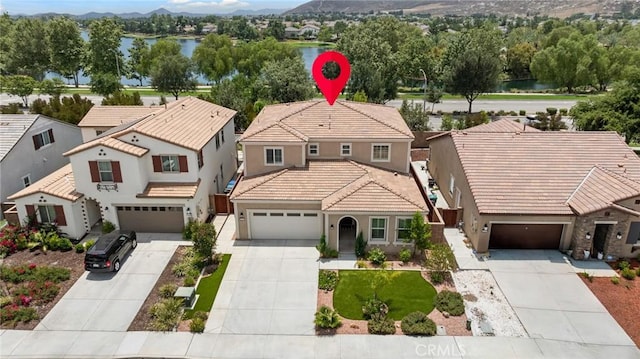 29273 Caravel Dr, Menifee, CA 92585 - view of front facade with a water and mountain view, driveway, and stucco siding