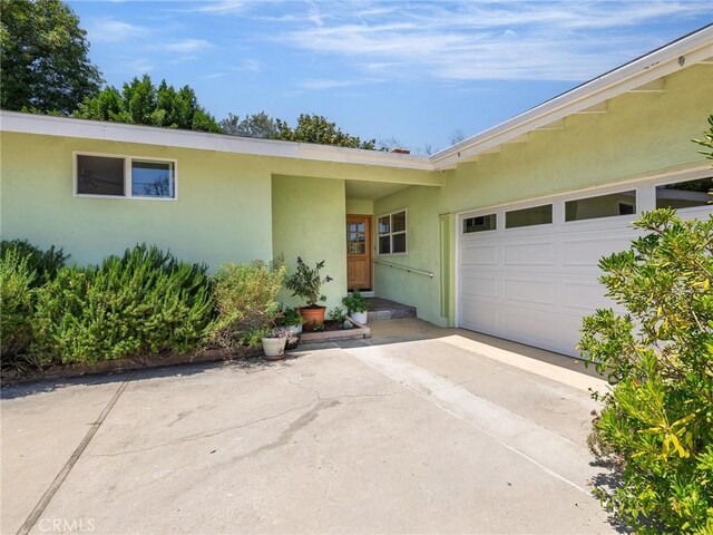 2049 Avenida Aprenda, Rancho Palos Verdes, CA 90275 - view of exterior entry featuring stucco siding, driveway, and a garage
