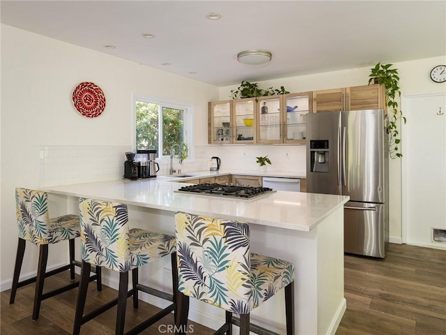 2049 Avenida Aprenda, Rancho Palos Verdes, CA 90275 - kitchen featuring stainless steel appliances, glass insert cabinets, a kitchen bar, a peninsula, and tasteful backsplash