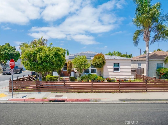 1335 W Burnett St, Long Beach, CA 90810 - view of front of home featuring a fenced front yard and roof mounted solar panels