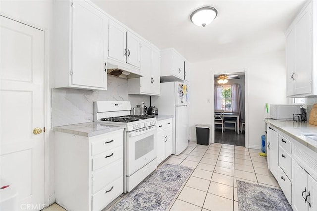 1335 W Burnett St, Long Beach, CA 90810 - kitchen featuring white appliances, under cabinet range hood, tasteful backsplash, and white cabinetry