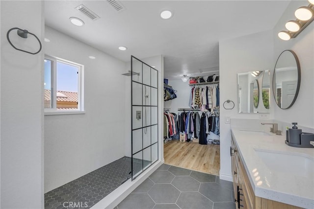 2578 Bryce Ct, Colton, CA 92324 - full bathroom featuring a shower stall, tile patterned flooring, double vanity, a walk in closet, and recessed lighting