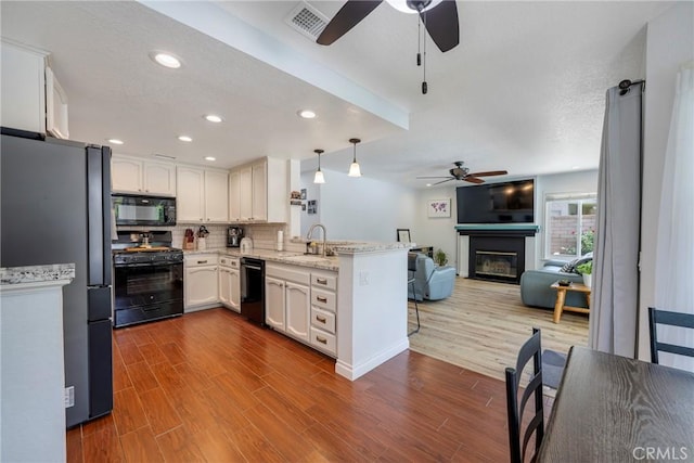 2578 Bryce Ct, Colton, CA 92324 - kitchen with black appliances, ceiling fan, a peninsula, open floor plan, and white cabinets