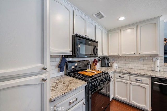 2578 Bryce Ct, Colton, CA 92324 - kitchen with black appliances, decorative backsplash, white cabinetry, light stone countertops, and wood finished floors