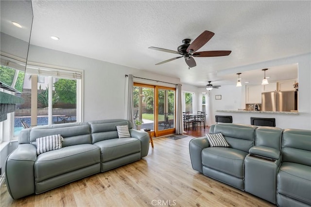 2578 Bryce Ct, Colton, CA 92324 - living area featuring a textured ceiling, ceiling fan, light wood-style floors, and recessed lighting