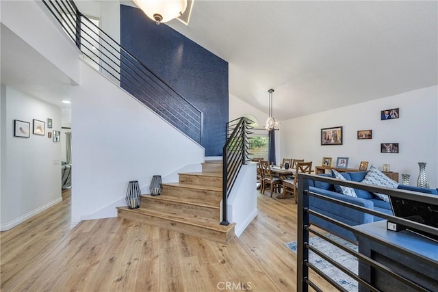 2578 Bryce Ct, Colton, CA 92324 - staircase featuring wood finished floors, a chandelier, and lofted ceiling