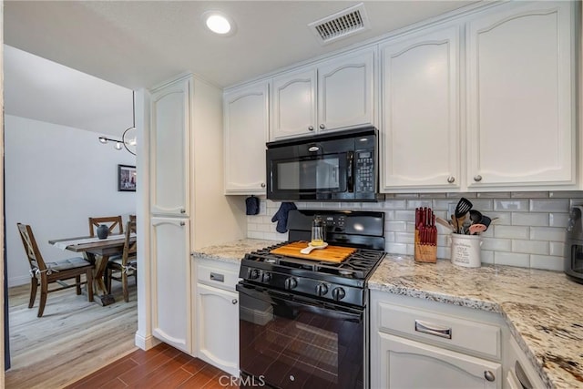 2578 Bryce Ct, Colton, CA 92324 - kitchen with black appliances, white cabinets, dark wood-style floors, decorative backsplash, and light stone counters