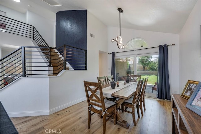 2578 Bryce Ct, Colton, CA 92324 - dining area with wood finished floors, stairs, a chandelier, and high vaulted ceiling