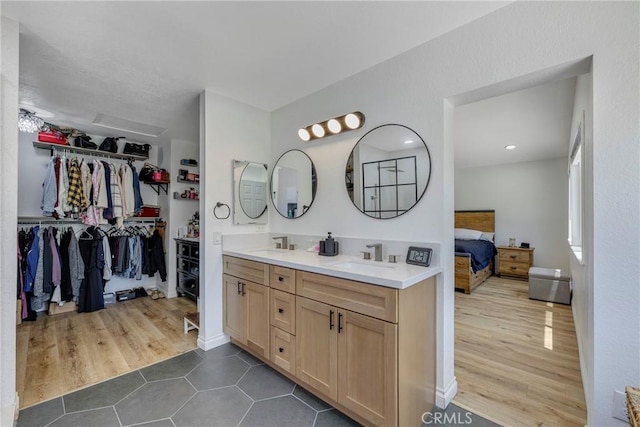 2578 Bryce Ct, Colton, CA 92324 - bathroom featuring double vanity, tile patterned flooring, ensuite bathroom, and a walk in closet