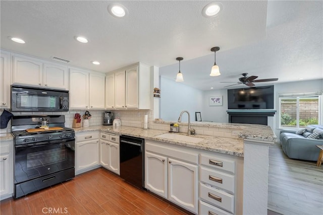 2578 Bryce Ct, Colton, CA 92324 - kitchen featuring black appliances, a peninsula, open floor plan, ceiling fan, and white cabinetry