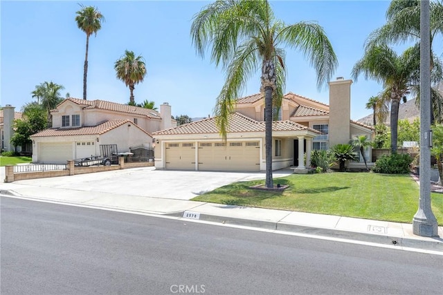2578 Bryce Ct, Colton, CA 92324 - mediterranean / spanish-style home with a tile roof, an attached garage, a front yard, and stucco siding