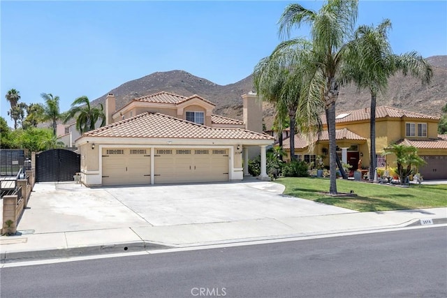 2578 Bryce Ct, Colton, CA 92324 - mediterranean / spanish house with an attached garage, stucco siding, a tile roof, a mountain view, and concrete driveway