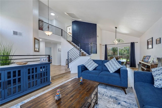 2578 Bryce Ct, Colton, CA 92324 - living area featuring wood finished floors, high vaulted ceiling, and stairs