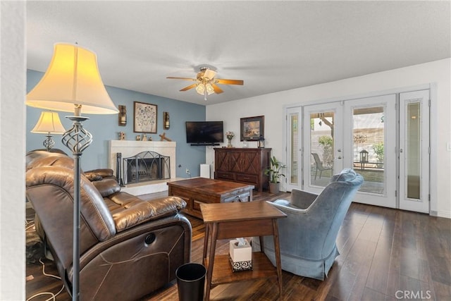 44125 Dusty Rd, Lancaster, CA 93536 - living room featuring french doors, ceiling fan, a fireplace with raised hearth, and wood-type flooring