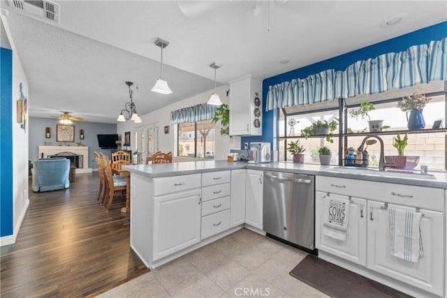 44125 Dusty Rd, Lancaster, CA 93536 - kitchen with dishwasher, ceiling fan, a peninsula, white cabinetry, and decorative light fixtures