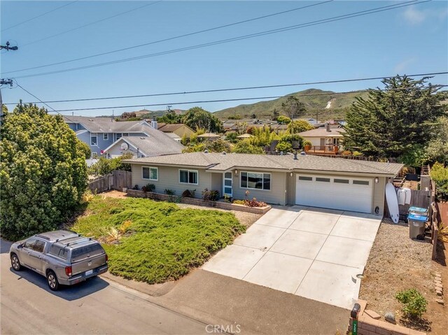 733 Lilac Dr, Los Osos, CA 93402 - view of front of home featuring a garage, a mountain view, concrete driveway, and a residential view