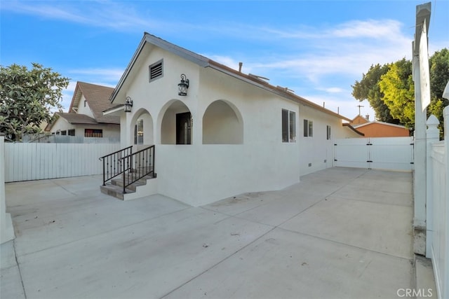2697 Merced St, Los Angeles, CA 90065 - view of front of home with a gate, stucco siding, and a patio area