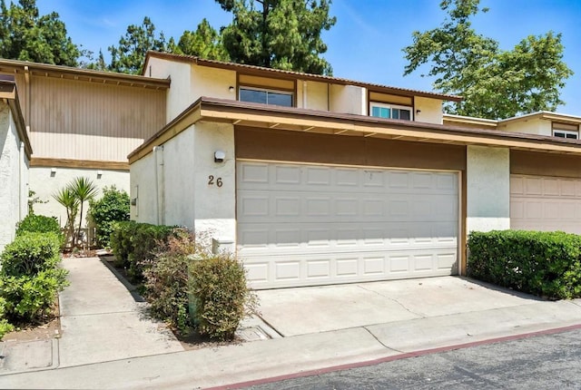 575 Otay Lakes Rd Unit 26, Chula Vista, CA 91913 - view of front of house featuring stucco siding, a garage, and driveway