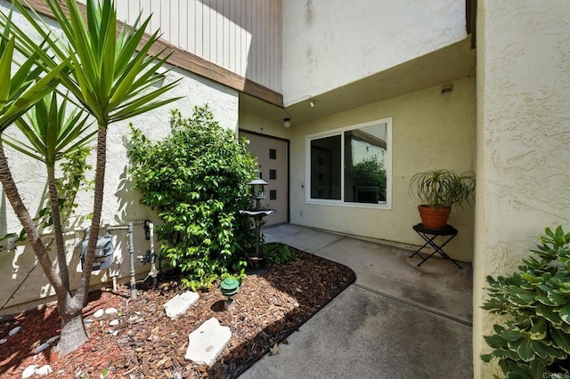 575 Otay Lakes Rd Unit 26, Chula Vista, CA 91913 - view of exterior entry with stucco siding and a patio area